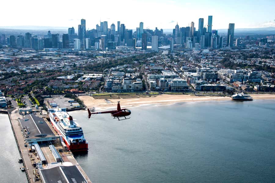 Melbourne: Private City & Beaches Helicopter Ride - Docklands, Melbourne Star, and the route toward Port Phillip Bay